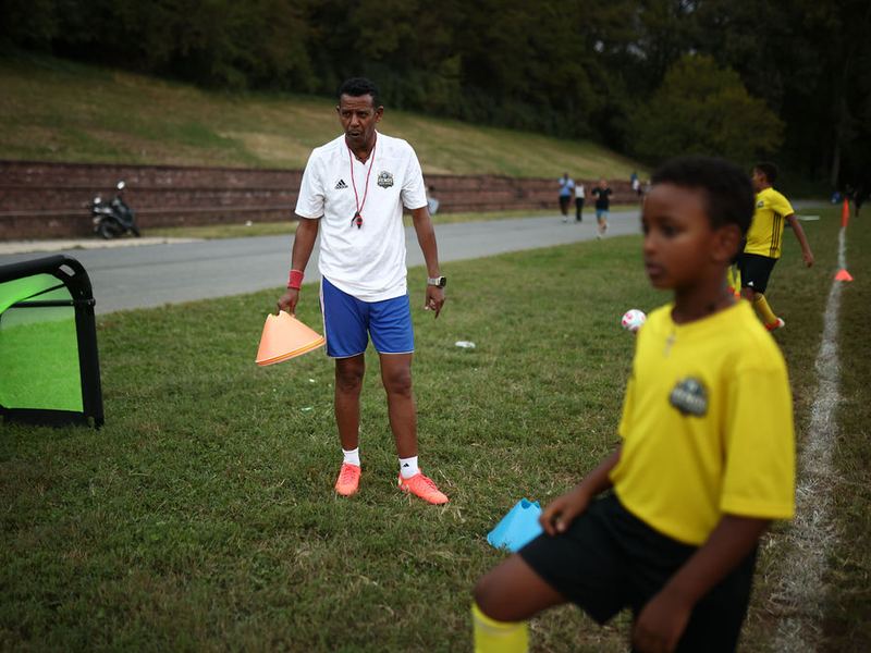 Coach Awet setting up cones for a one on one session with a player