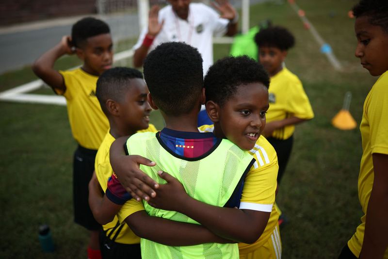 Two teammates hugging after a drill